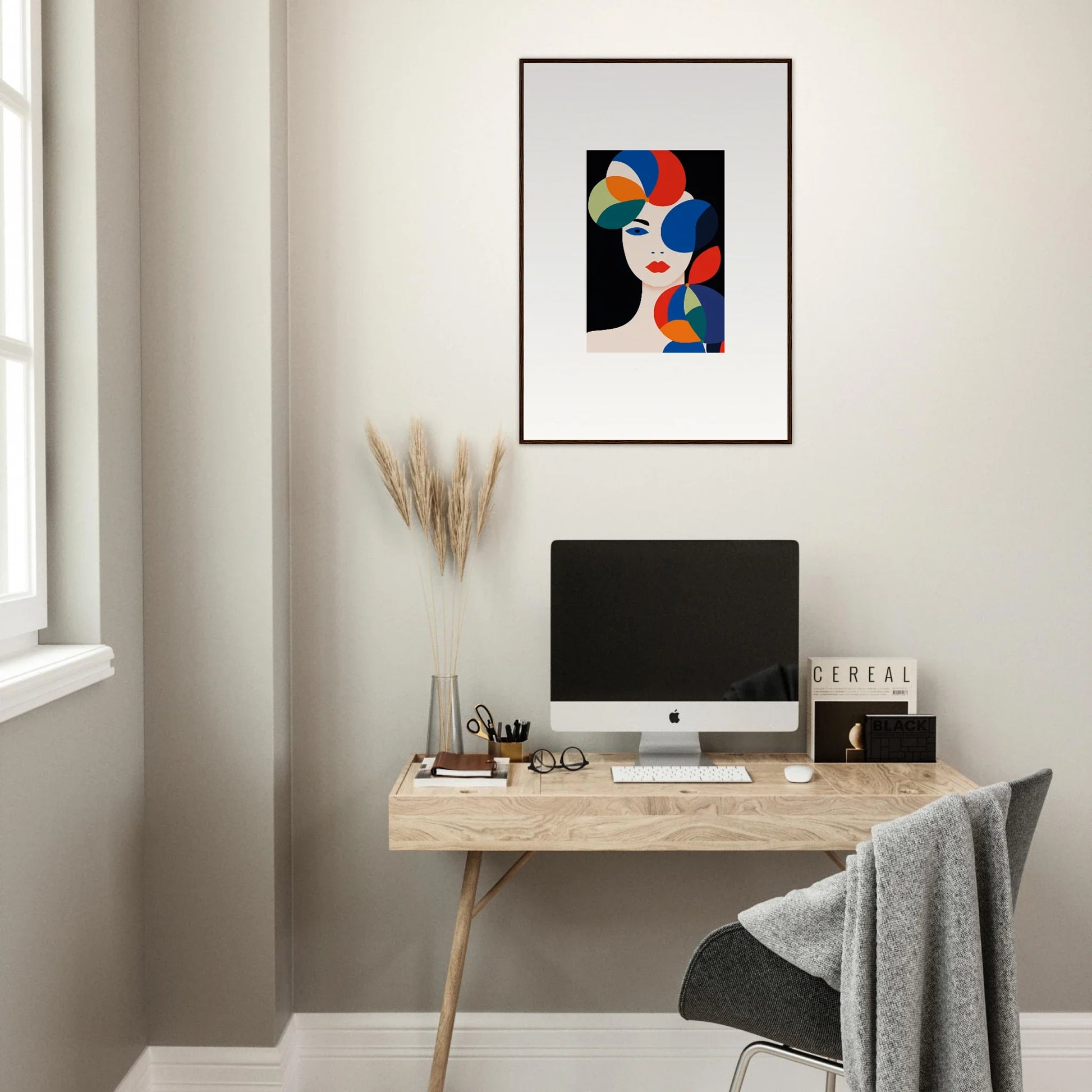 Minimalist home office with wooden desk, computer, and Petal Echoes canvas print