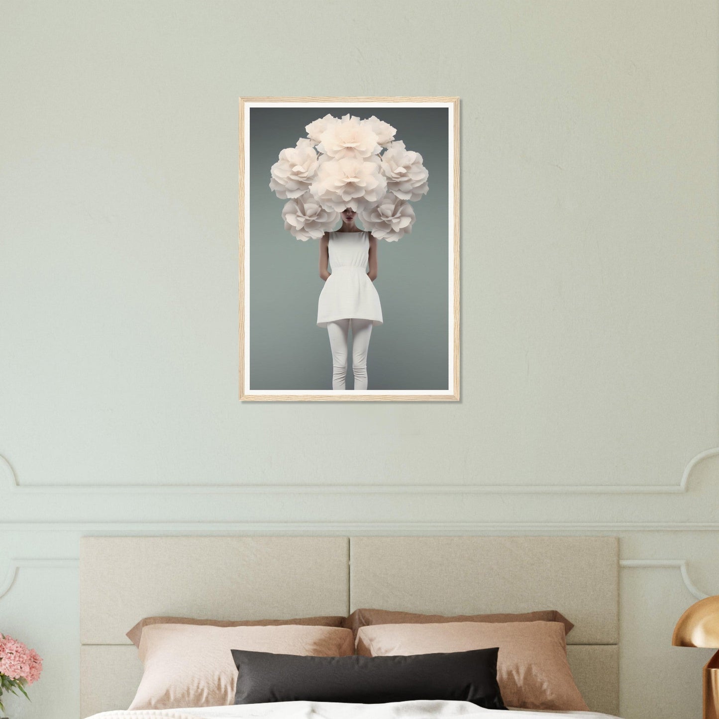 Framed artwork depicting a figure in a white dress with an oversized floral headpiece obscuring their face.