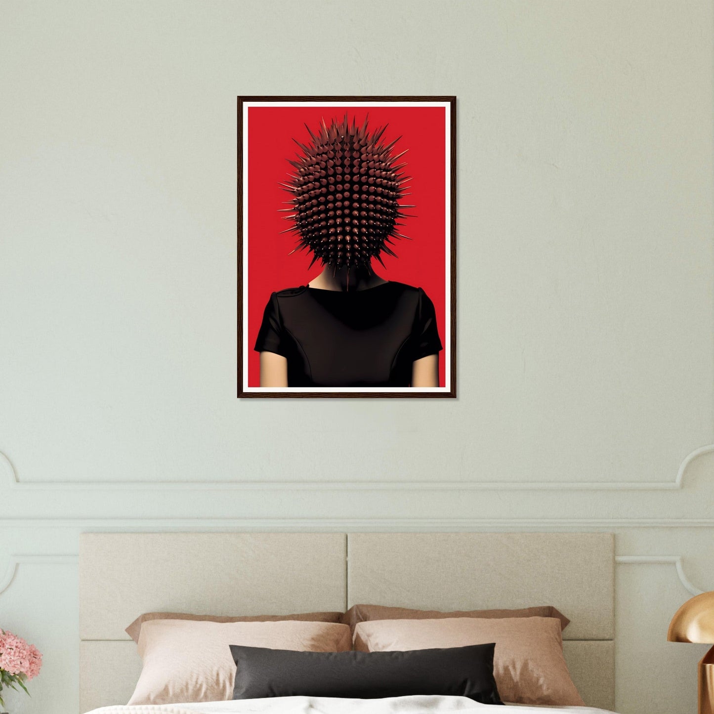 Framed artwork depicting a figure with a spiky, cactus-like head against a red background.