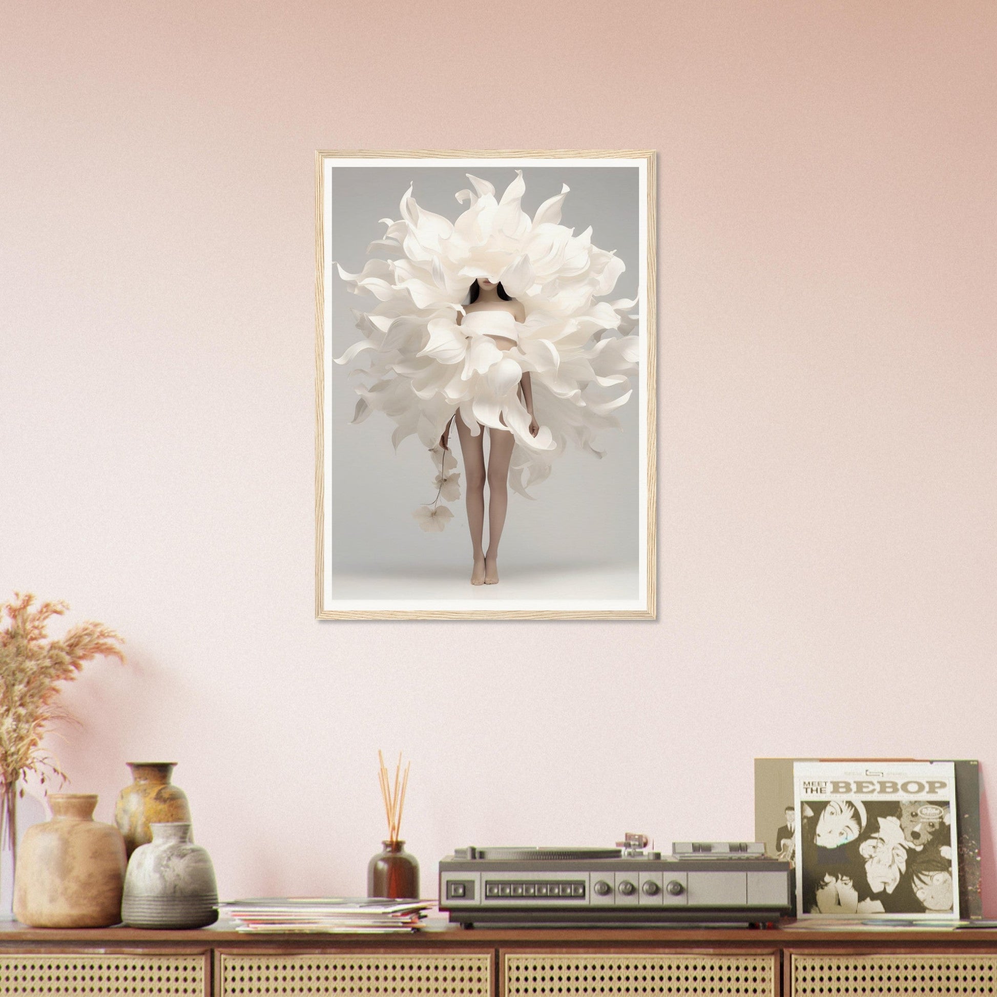 A white flower in a room with pink walls