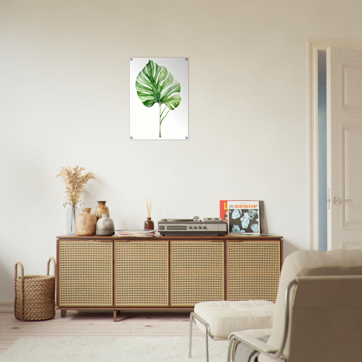 A white wall with a green leaf on it