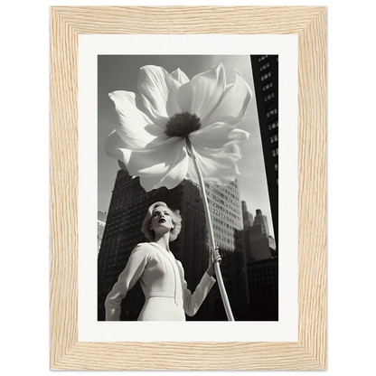 A woman holding a large white flower in front of a tall building