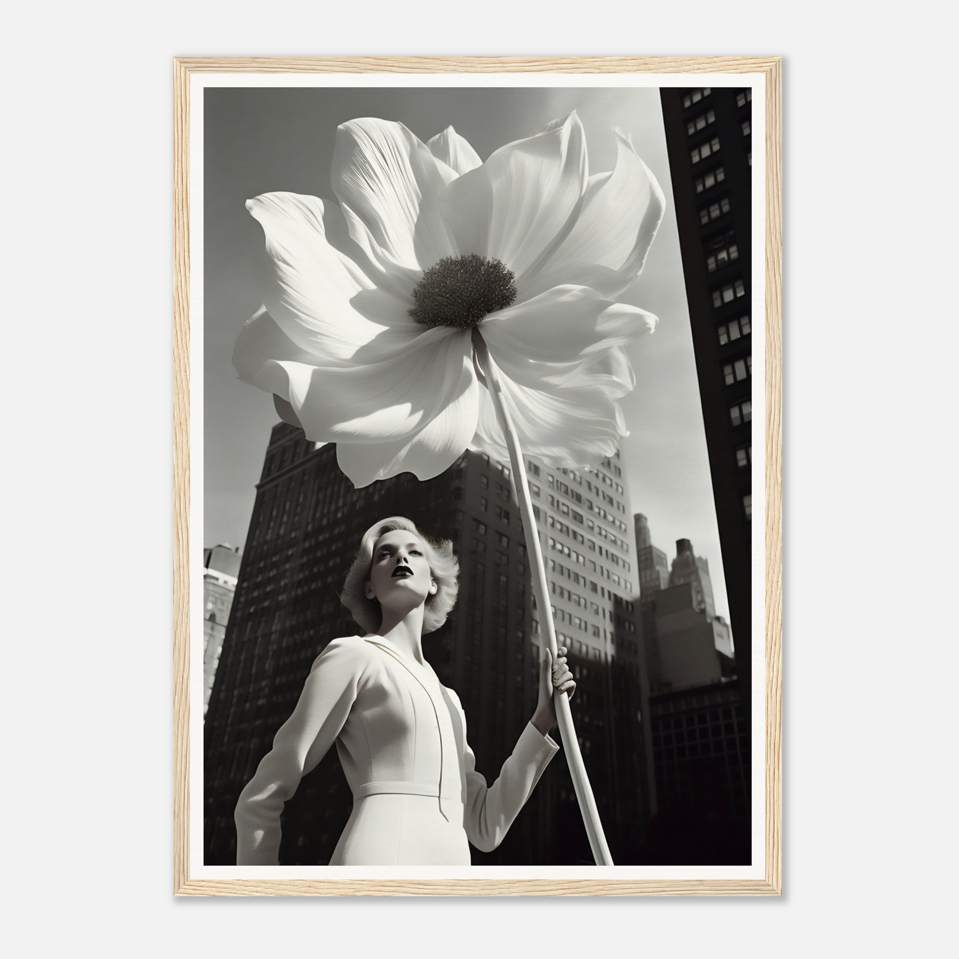 A woman holding a large white flower in front of a tall building