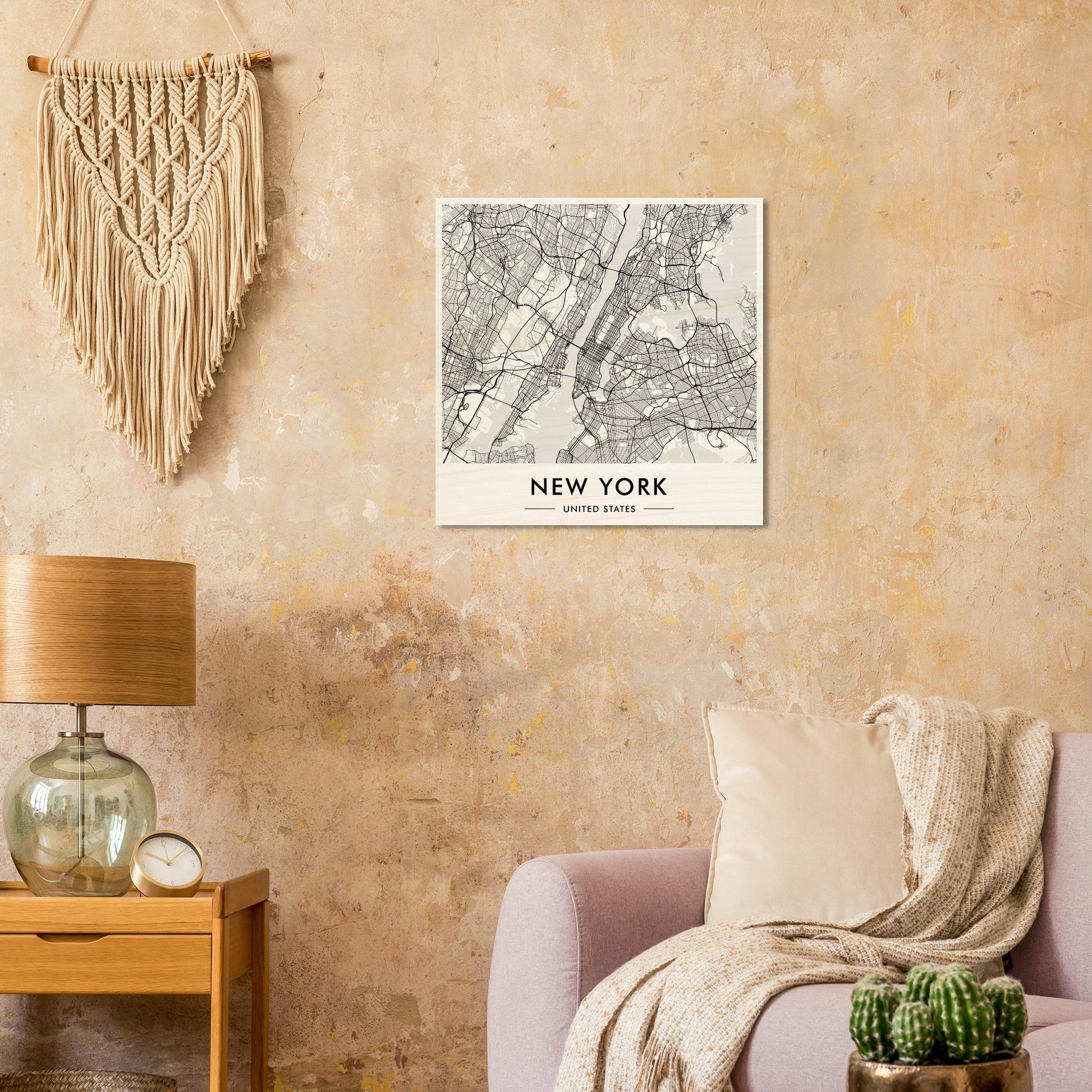 Macramé wall hanging with fringe above a New York City map print.